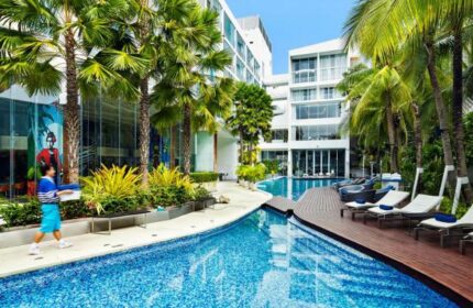 Baraquda Pattaya Mgallery gay-friendly hotel pool. Tropical landscaping, modern architecture, and inviting pool loungers create a relaxing gay travel vibe.