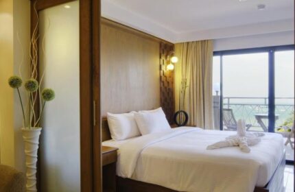 Baywalk Residence gay-friendly hotel room. Queen bed with swan towels, balcony view. Modern design, comfortable stay. Perfect for gay travel.