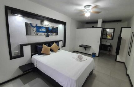 Beach Energy Hotel By BFH room. Gay-friendly hotel with bed, modern decor, and bathroom. Ideal for gay men's travel. Stylish, relaxing stay.