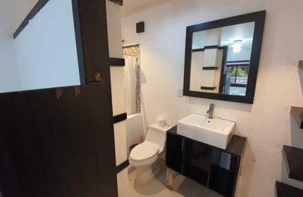 Bathroom at Beach Energy Hotel By BFH, a gay-friendly hotel. Features a toilet, shower, sink, and mirror. Great for gay men's travel.