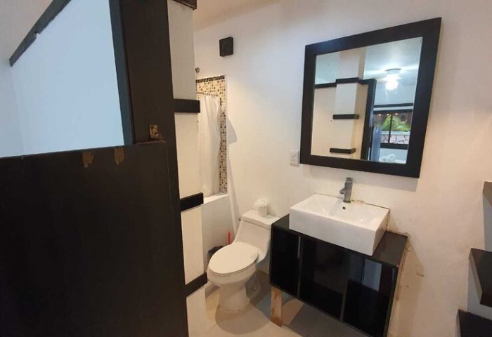 Bathroom at Beach Energy Hotel By BFH, a gay-friendly hotel. Features a toilet, shower, sink, and mirror. Great for gay men's travel.