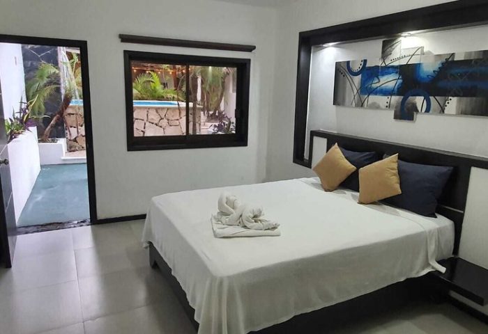 Beach Energy Hotel room. Gay-friendly hotel by BFH. King bed, pool view, modern art. Ideal for gay men travel.