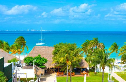 Beachscape Kin Ha Villas & Suites Cancun view. Gay-friendly hotel with beach, palms, and turquoise sea. Ideal gay travel destination.