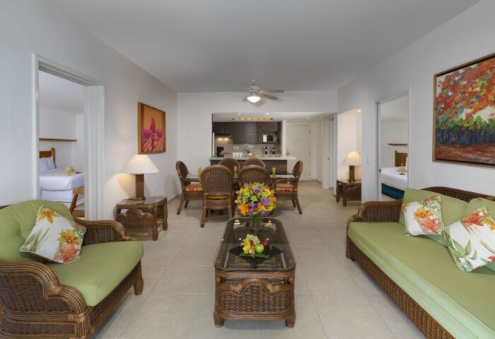 Beachscape Kin Ha Villas & Suites Cancun interior. Gay-friendly hotel suite with dining area, living room, and partial kitchen view.