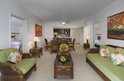 Beachscape Kin Ha Villas & Suites Cancun interior. Gay-friendly hotel suite with dining area, living room, and partial kitchen view.