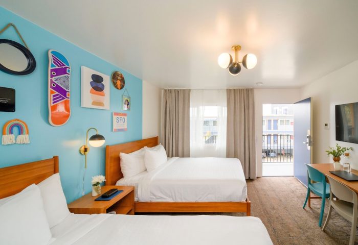 Beck's Motor Lodge gay-friendly hotel room. Two beds, desk, TV, balcony. Fun, modern decor, San Francisco lodging for gay travelers.