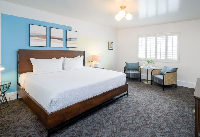 Beck's Motor Lodge gay-friendly hotel room. Modern design with a large bed, seating area, and stylish decor. Ideal for gay travel lodging.