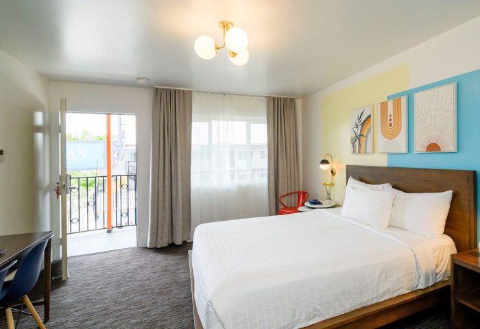 Beck's Motor Lodge gay-friendly hotel room. Bright, modern decor, queen bed, desk, and balcony. Ideal lodging for gay travelers.