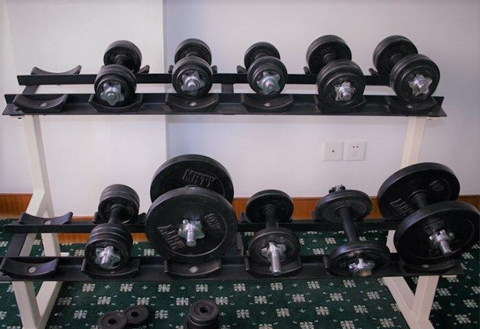 Weights at Beijing Guoan Hotel gym. Gay-friendly hotel with fitness center. Dumbbells on rack for guest use. Hotel for gay men in Beijing.