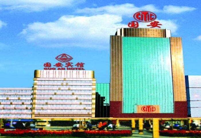 Beijing Guoan Hotel exterior. Gay-friendly hotel in Beijing, China. Modern architecture with blue sky. Travel destination for gay men.