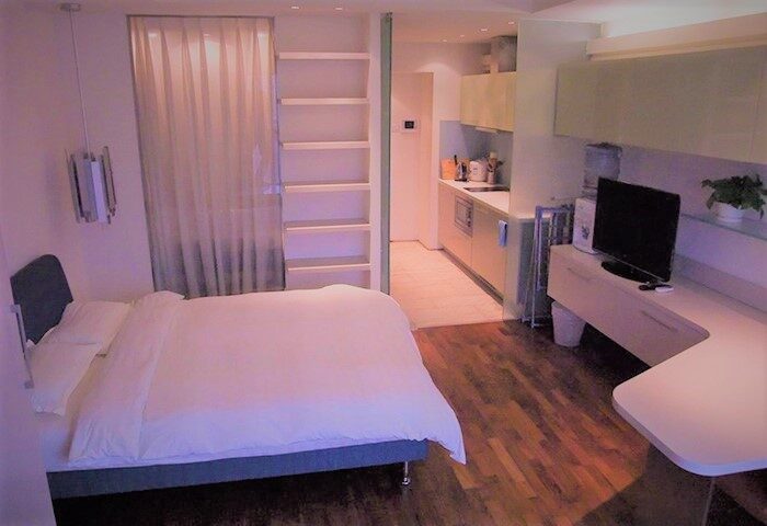 Beijing New Oriental Suites in Seasons Park Sanlitun: Modern suite with bed, kitchen, and TV. Gay-friendly hotel in Beijing, China.