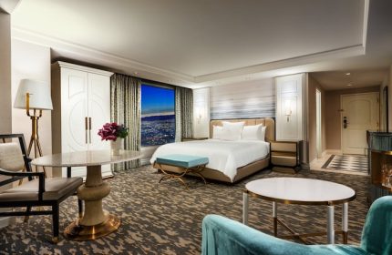 Bellagio Hotel room. Gay-friendly hotel with a king bed, city view, seating area, and elegant decor. Luxury gay travel in Las Vegas.