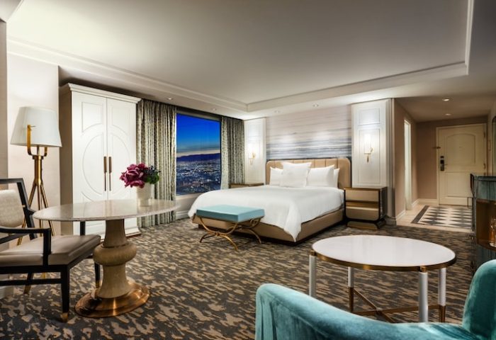 Bellagio Hotel room. Gay-friendly hotel with a king bed, city view, seating area, and elegant decor. Luxury gay travel in Las Vegas.
