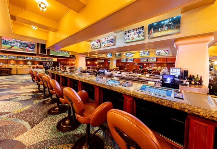 Gay-friendly Bellagio Hotel sports bar in Las Vegas. Leather chairs line the bar with multiple TVs showing sports. A great place for gay men to relax.