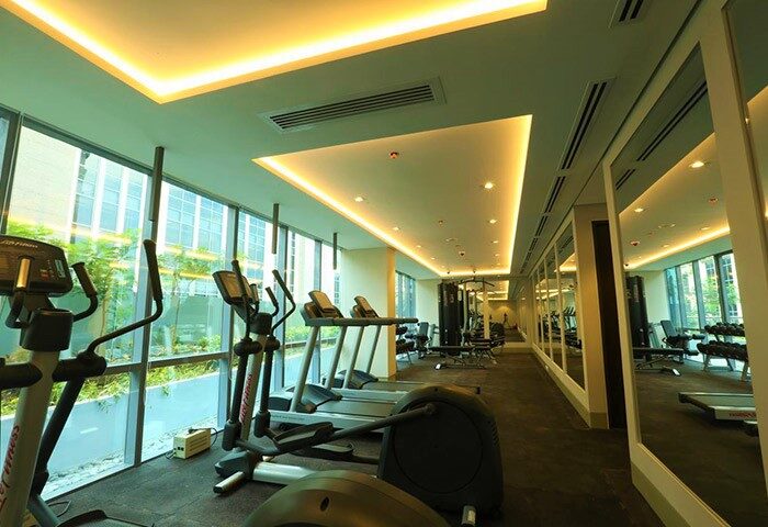Belmont Hotel Manila gym. Gay-friendly hotel fitness center with treadmills, elliptical machines, weights. Modern equipment, mirrors, bright lighting.