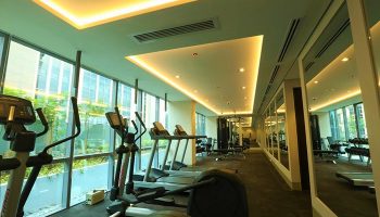 Belmont Hotel Manila gym. Gay-friendly hotel fitness center with treadmills, elliptical machines, weights. Modern equipment, mirrors, bright lighting.