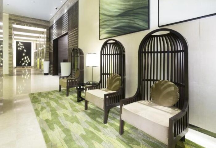 Belmont Hotel Manila lobby seating area. Stylish chairs, modern decor, and a welcoming ambiance. Gay-friendly hotel design.