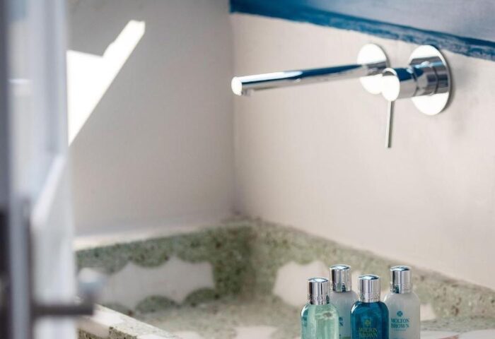 Belvedere Little Venice Pied-a-Terres bathroom detail. Modern sink, blue trim, and toiletries. Gay-friendly hotel for discerning travelers.