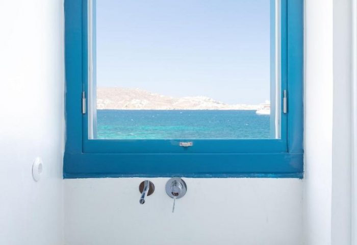 Belvedere Little Venice Pied-a-Terres bath. Blue window frames sea view. Terrazzo sink, towels. Gay-friendly hotel bathroom design.