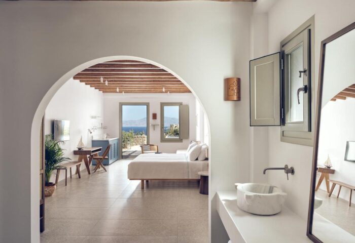 Belvedere Mykonos Hilltop Complex gay-friendly hotel room. View of the bedroom and bathroom, with a sea view. Luxury travel for gay men.