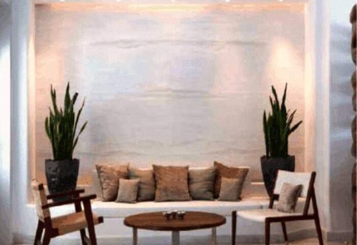 Belvedere Mykonos Hotel room detail. Elegant suite interior with plants, pillows, and chairs. Gay-friendly hotel rooms & suites.