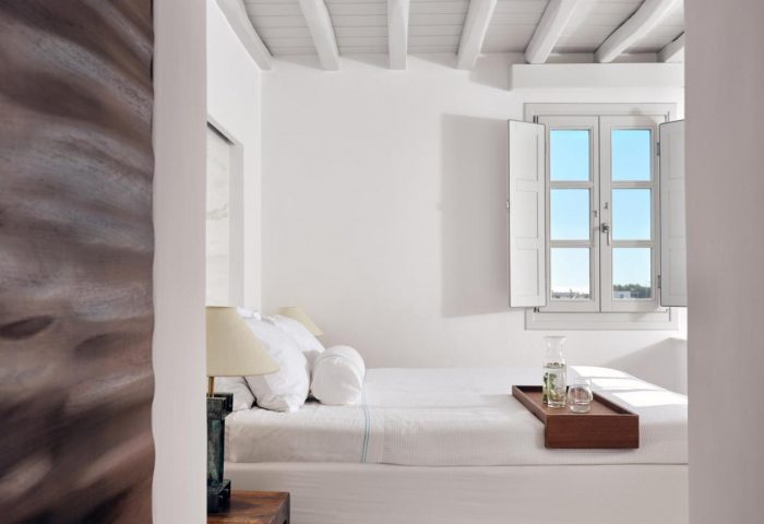 Belvedere Mykonos Hotel room. Minimalist white suite with tray on bed. Gay-friendly hotel rooms & suites in Mykonos, Greece.
