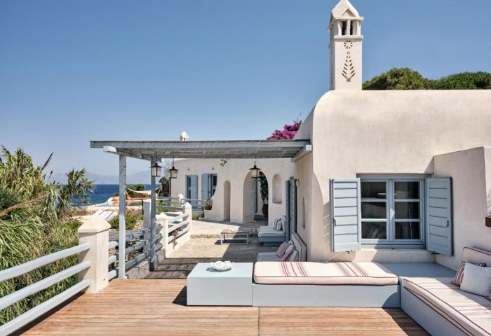 Belvedere Mykonos Waterfront Villa Suites. Gay-friendly hotel with white walls, blue trim, and a wooden deck overlooking the sea.