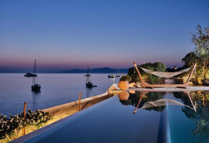Belvedere Mykonos Waterfront Villa & Suites: Gay-friendly hotel view at dusk. Hammock, pool, & Aegean Sea. Luxury gay travel.