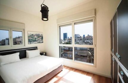 Ben Yehuda Apartments gay-friendly hotel room. Modern, bright bedroom with city view. Perfect for gay travelers in Tel Aviv.