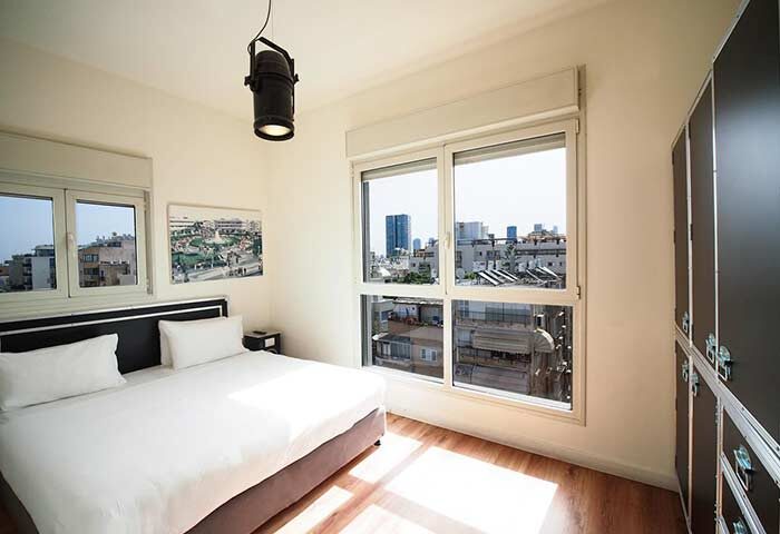 Ben Yehuda Apartments gay-friendly hotel room. Modern, bright bedroom with city view. Perfect for gay travelers in Tel Aviv.