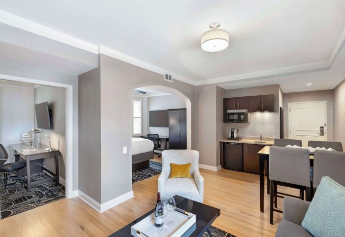 Best Western Plus Hawthorne Terrace Hotel's gay-friendly suite. Living area, kitchenette, bedroom, & workspace offer comfort.