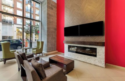Best Western Plus Hotel Montreal lobby. Gay-friendly hotel with modern design, fireplace, TV, and comfortable seating. Great for gay travelers.
