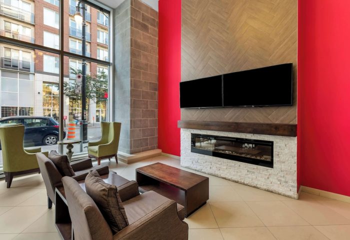 Best Western Plus Hotel Montreal lobby. Gay-friendly hotel with modern design, fireplace, TV, and comfortable seating. Great for gay travelers.