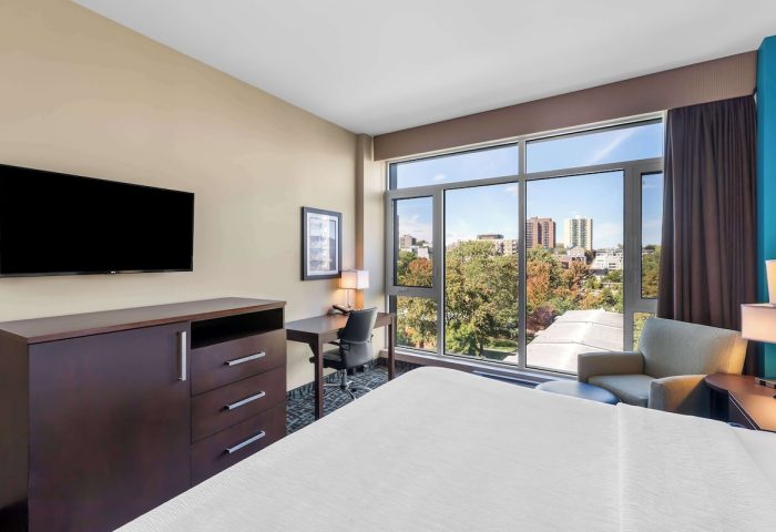 Best Western Plus Hotel Montreal guest room. Gay-friendly hotel with city view, desk, TV, and comfortable chair. Modern interior design.