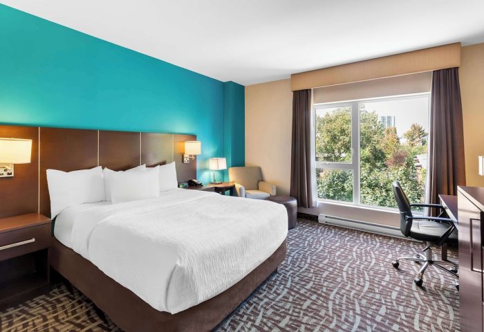 Bedroom at the Gay-Friendly Best Western Plus Hotel Montreal. King bed, desk, chair, and a view. A great choice for gay travelers.