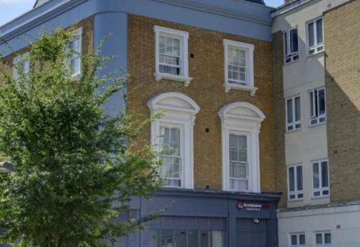 Best Western Plus Vauxhall Hotel, a gay-friendly hotel in London. Facade of the hotel with trees and a planter in front. Vauxhall gay travel.