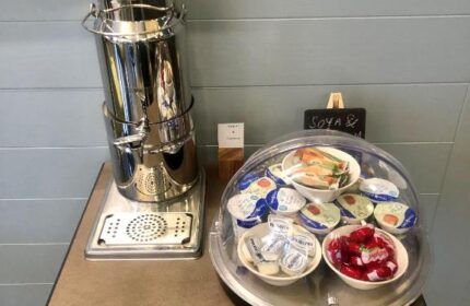 Breakfast bar at Best Western Plus Vauxhall Hotel, a gay-friendly hotel. It features yogurt, fruit, and a beverage dispenser.