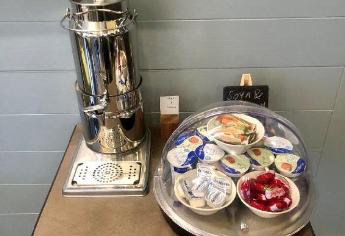 Breakfast bar at Best Western Plus Vauxhall Hotel, a gay-friendly hotel. It features yogurt, fruit, and a beverage dispenser.