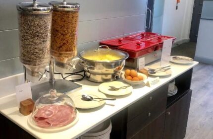 Breakfast buffet at Best Western Plus Vauxhall Hotel, a gay-friendly hotel. Cereal, scrambled eggs, ham, and other options are available.