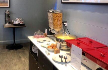 Breakfast buffet at Best Western Plus Vauxhall Hotel, a gay-friendly hotel. Cereal, eggs, hot dishes, plates, and utensils are visible.