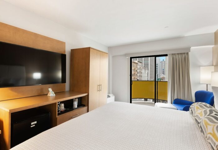 Best Western Red Coach Inn gay-friendly hotel room. Features a TV, balcony, and city view. Great for gay men travel.