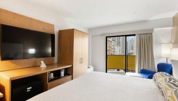 Best Western Red Coach Inn gay-friendly hotel room. Features a TV, balcony, and city view. Great for gay men travel.