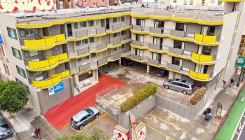 Best Western Red Coach Inn, a gay-friendly hotel. The hotel's exterior features yellow accents and a red entrance. Parking available.