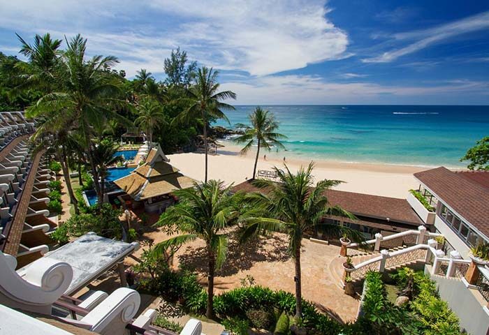 Gay-Friendly Beyond Resort Karon view. Beachfront hotel with palm trees, pool, & ocean views. Ideal for gay travel in Karon, Phuket, Thailand.