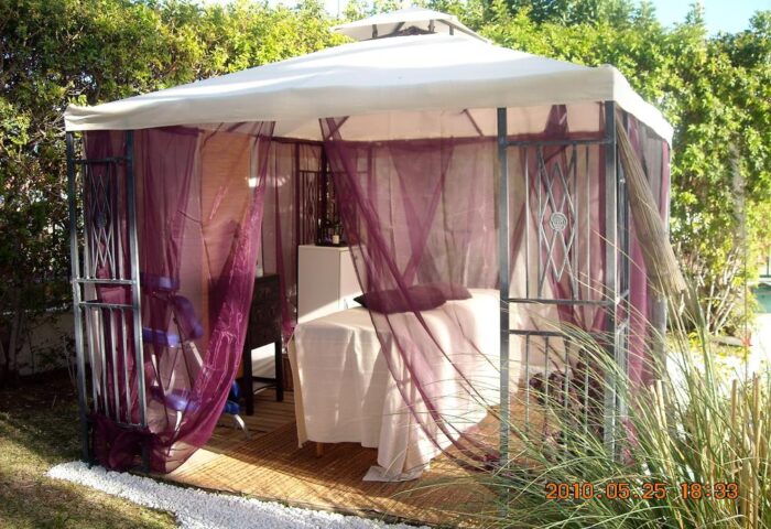 Outdoor massage gazebo at Birdcage Gay Men Resort & Lifestyle Hotel. Relaxing spa area for gay travel, wellness, and lifestyle.