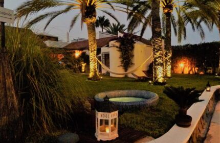Birdcage Gay Men Resort and Lifestyle Hotel garden view. Hammock, palm trees, and hot tub create a relaxing gay-friendly atmosphere.