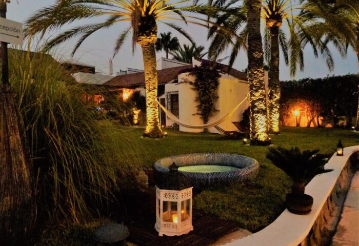 Birdcage Gay Men Resort and Lifestyle Hotel garden view. Hammock, palm trees, and hot tub create a relaxing gay-friendly atmosphere.