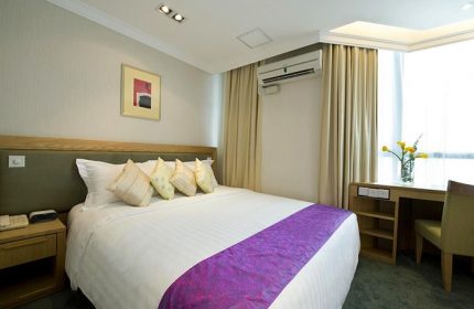 Bishop Lei International House room. Gay-friendly hotel with bed, desk, and air conditioning. Modern decor. Comfortable stay for gay travelers.