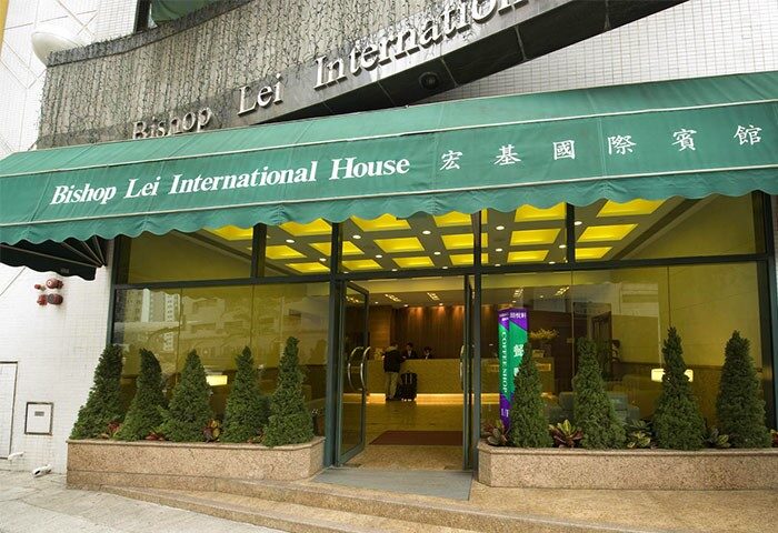 Bishop Lei International House entrance. Gay-friendly hotel in Hong Kong. Facade view with awning and glass doors. Travel advice for gay men.