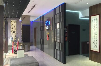 Bliss Hotel Singapore lobby. Gay-friendly hotel with modern design, blue lighting, and Asian-inspired decor. A comfortable and welcoming space.